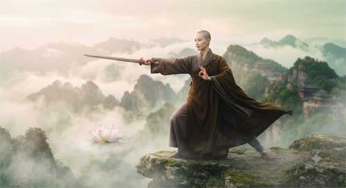 Monja budista en postura elegante de espada con flor de loto flotando cerca, fondo de montaña neblinoso
